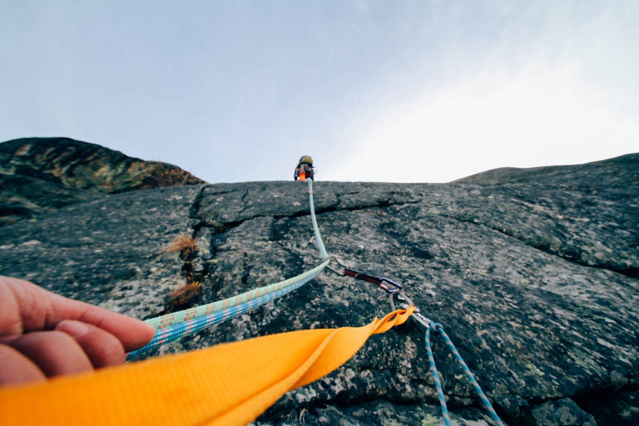 The Art of Drawing Readers In: Your attractive post title goes here Capture the thrill of rock climbing with this dynamic low-angle shot showcasing determination and teamwork.